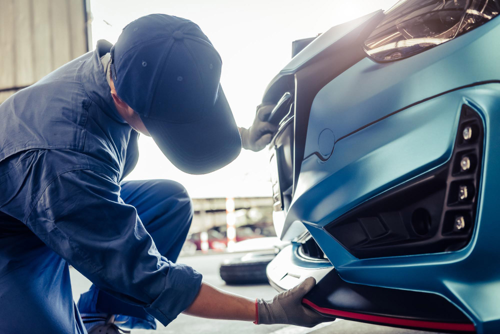 Smash repairs Melbourne technician repairing damaged car panel