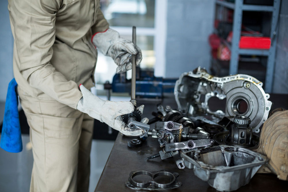 Technician examining the identification label and manufacturer markings on a used Toyota component