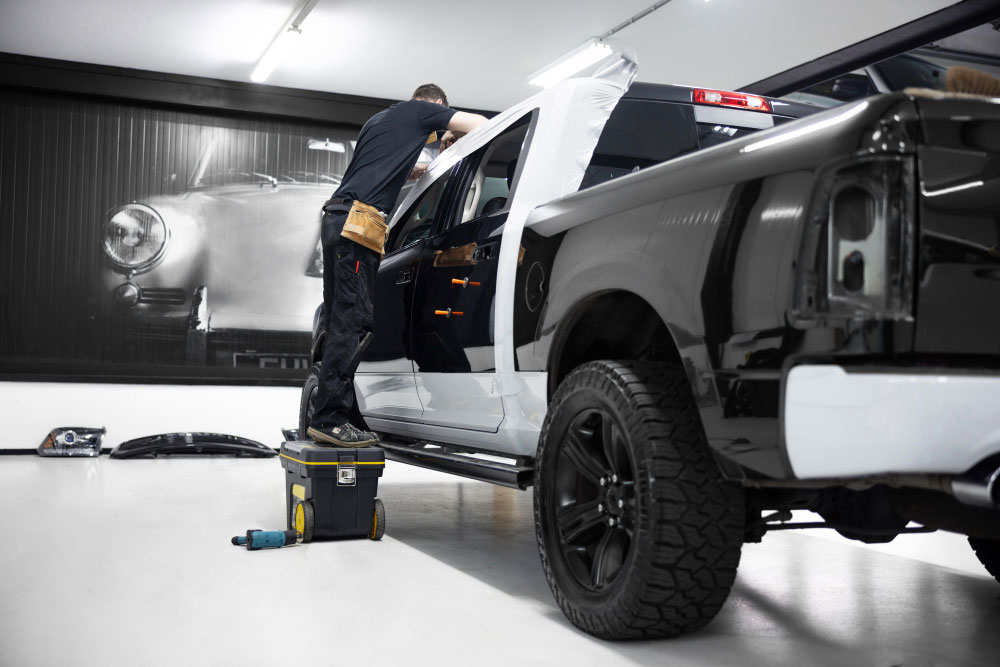 Replacement Toyota Hilux door beside the vehicle with its wiring and inner fittings visible