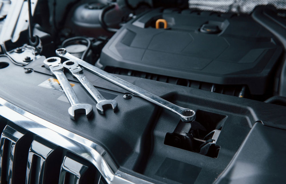 Toyota Hilux front end being inspected for damaged bumper, headlight and mounting components